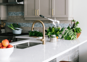 Sleek Kitchen Design with light gold accents and white marble countertop in Beverly, MA