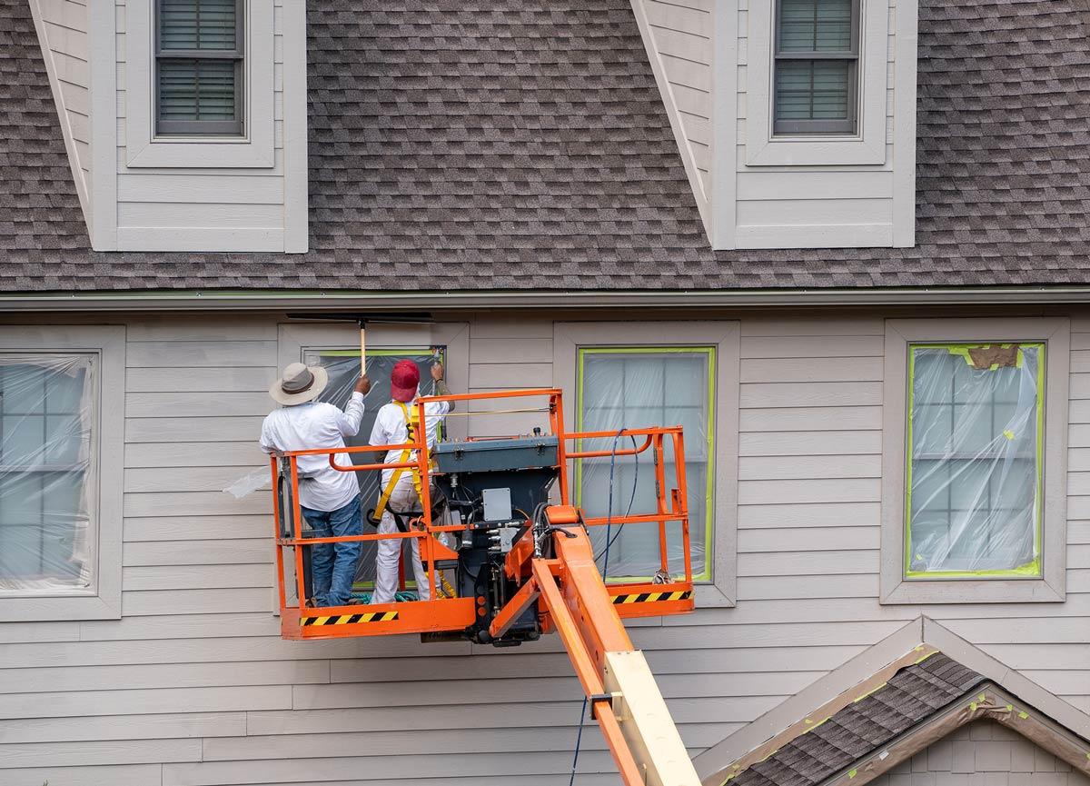 two painters on a lift providing services such as Painter, Indoor Painting, and Painting Company in Middleton, MA